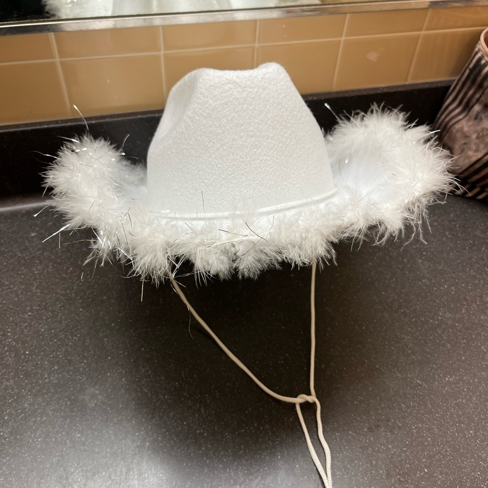 White Cowboy Hat
Fluff and glitter strips around the rim